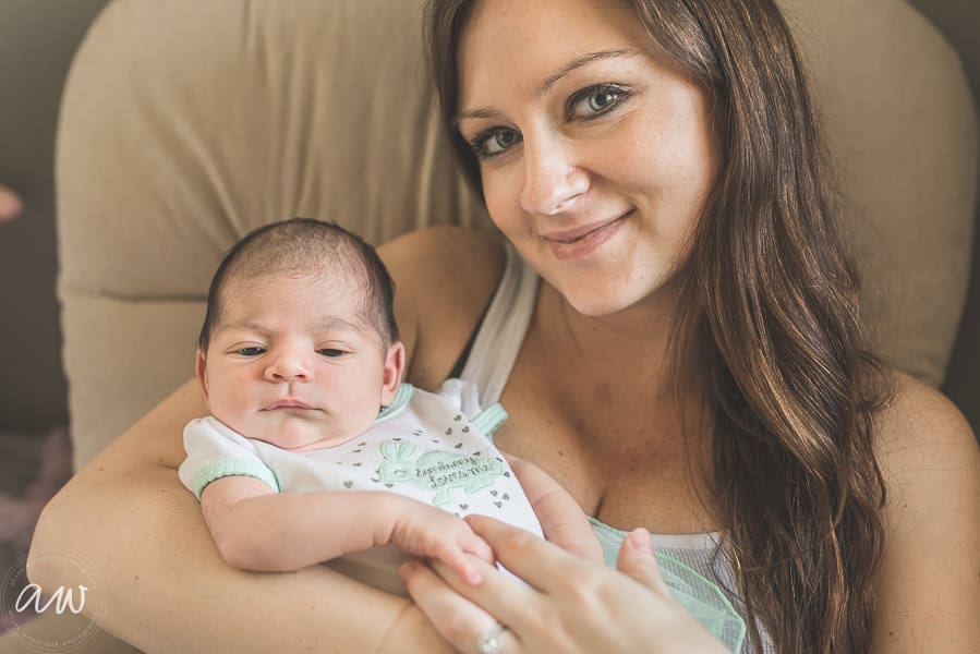mother with newborn baby in rocking chair