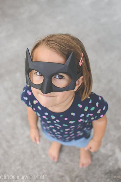 little girl wearing batman mask