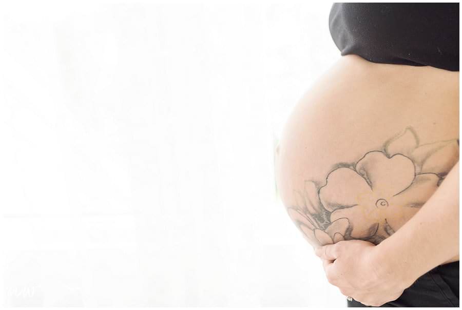 mom with pregnant belly and a tattoo.