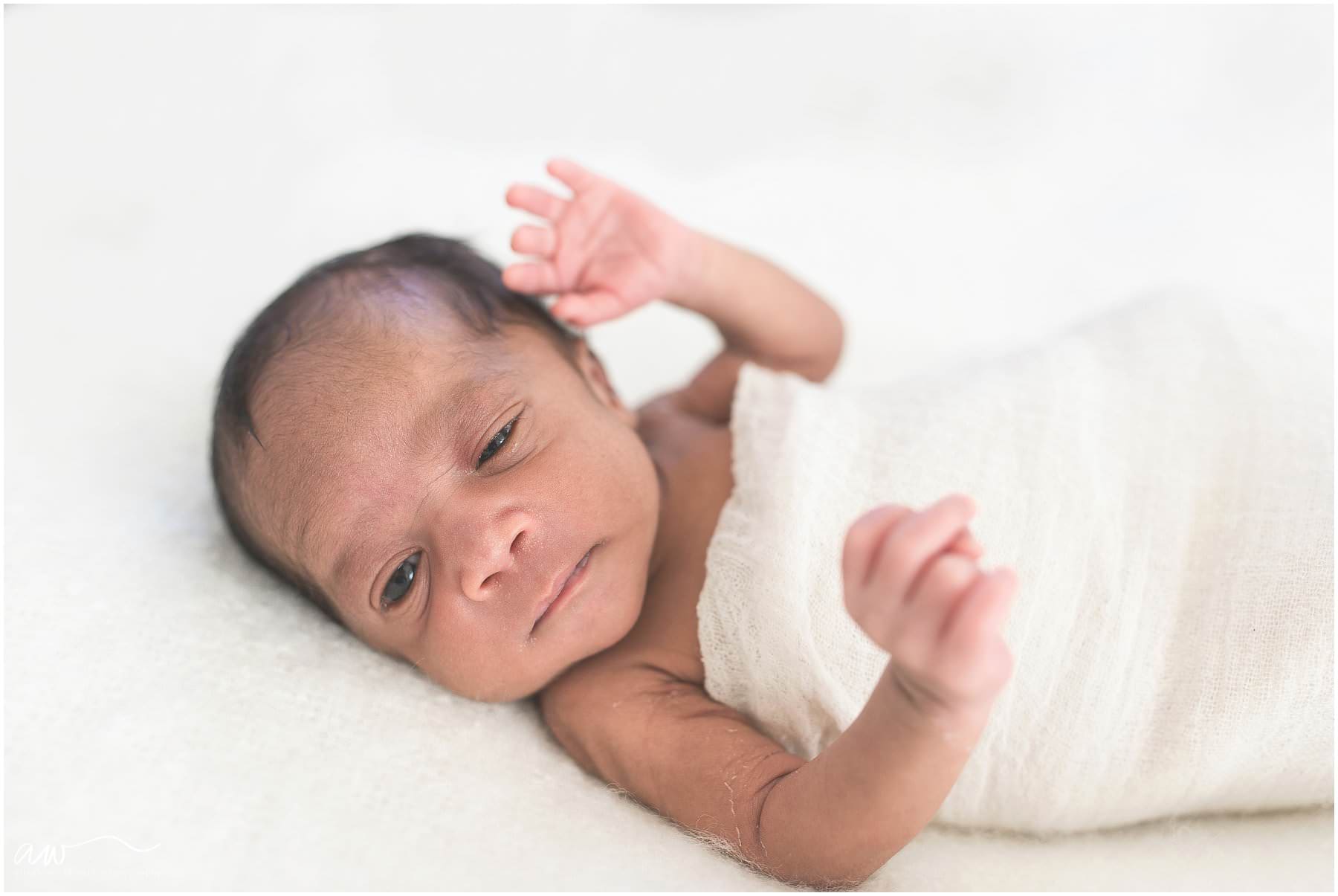 baby with his eyes open looking at the camera
