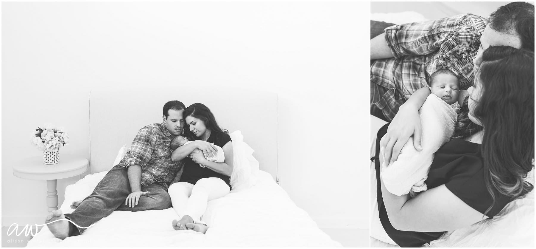 A gorgeous new family sits on a bed with their new baby {Florida's Newborn Photographer}