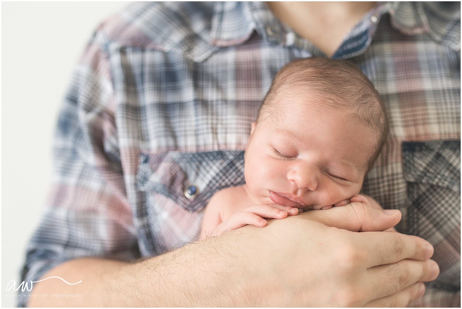 A sweet baby girl snuggles up on her daddy's chest {Tampas Newborn Photographer Alison Winterroth}