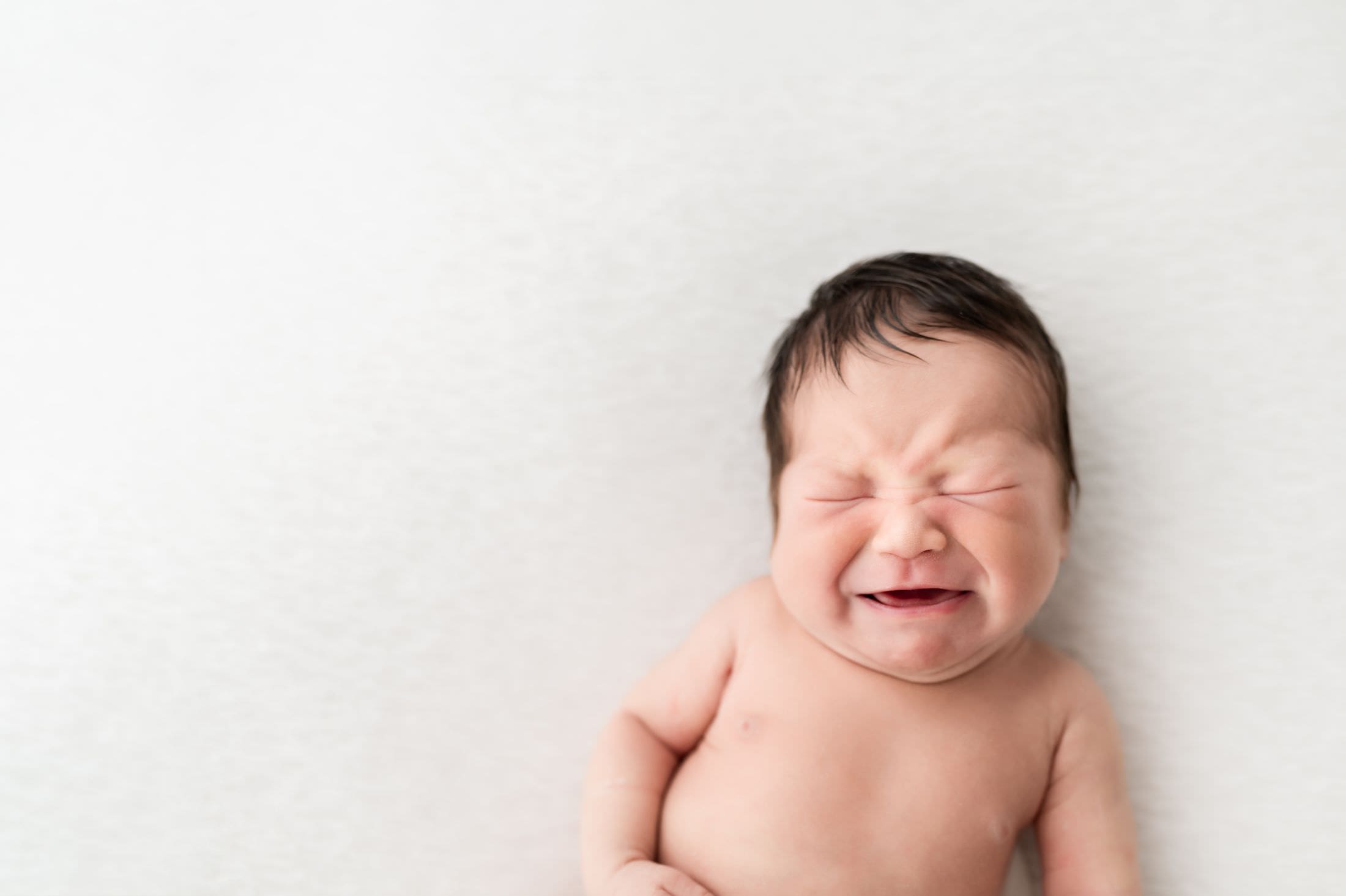 A baby making a cute crying face
