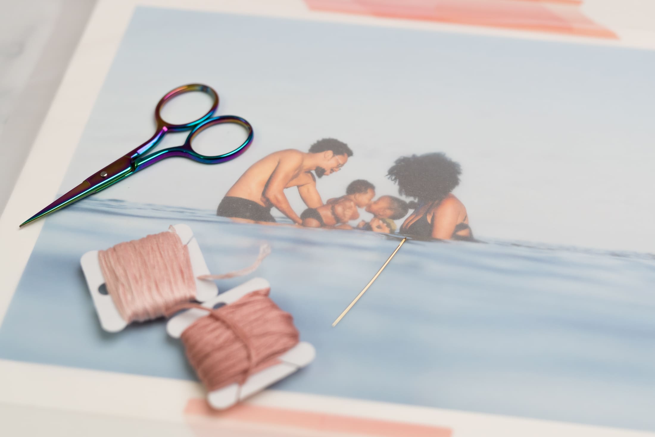 embroidery supplies on a print on a family at the beach