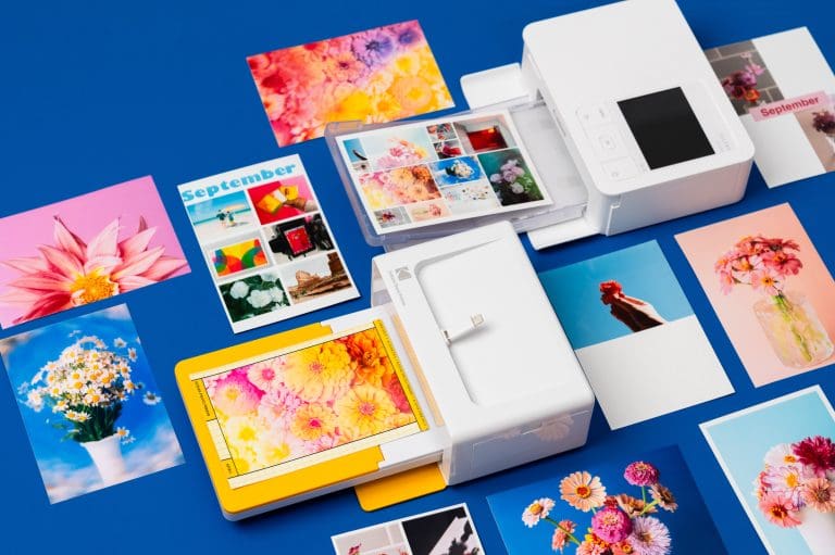canon selphy cp 1500 vs kodak dock 4pass instant printers lined up next to each other