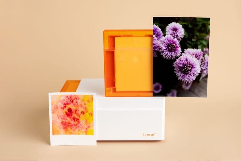 liene m110 printer on a tan background with two example photos with different colored flowers