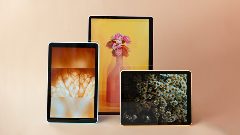 cream background with three apolosign neon photo frames with colorful flowers