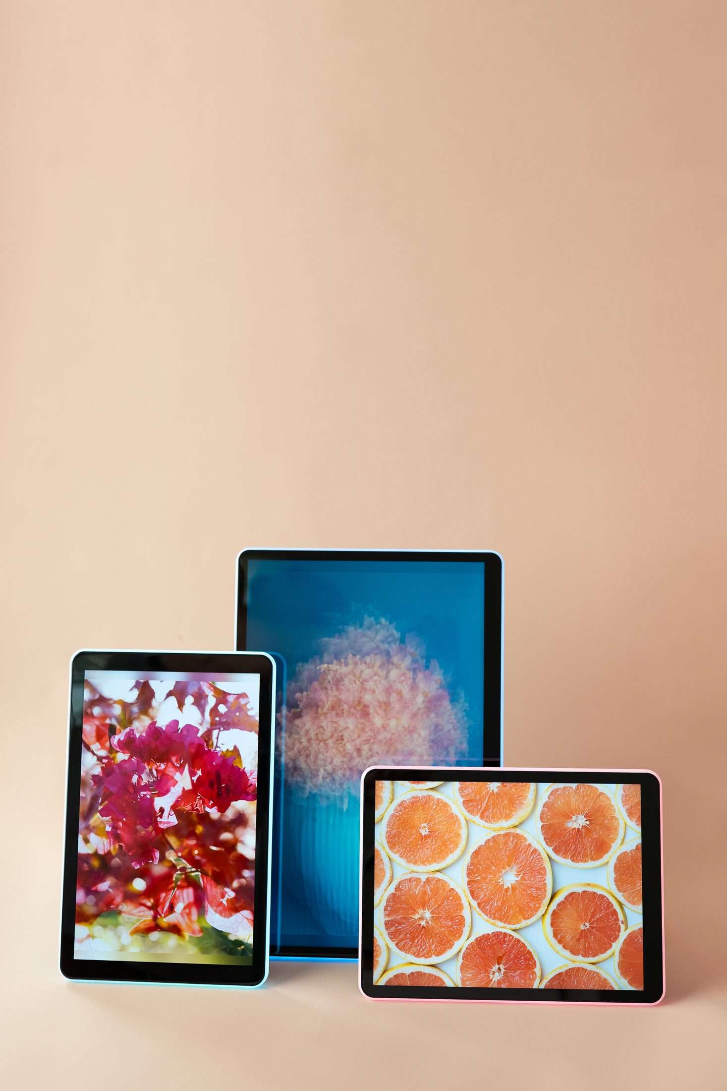 three colorful Apolosign Neon Light Digital Photo Frames on a tan background